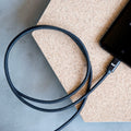 The braided nylon USB-C charging cable inserted into a USB-C phone